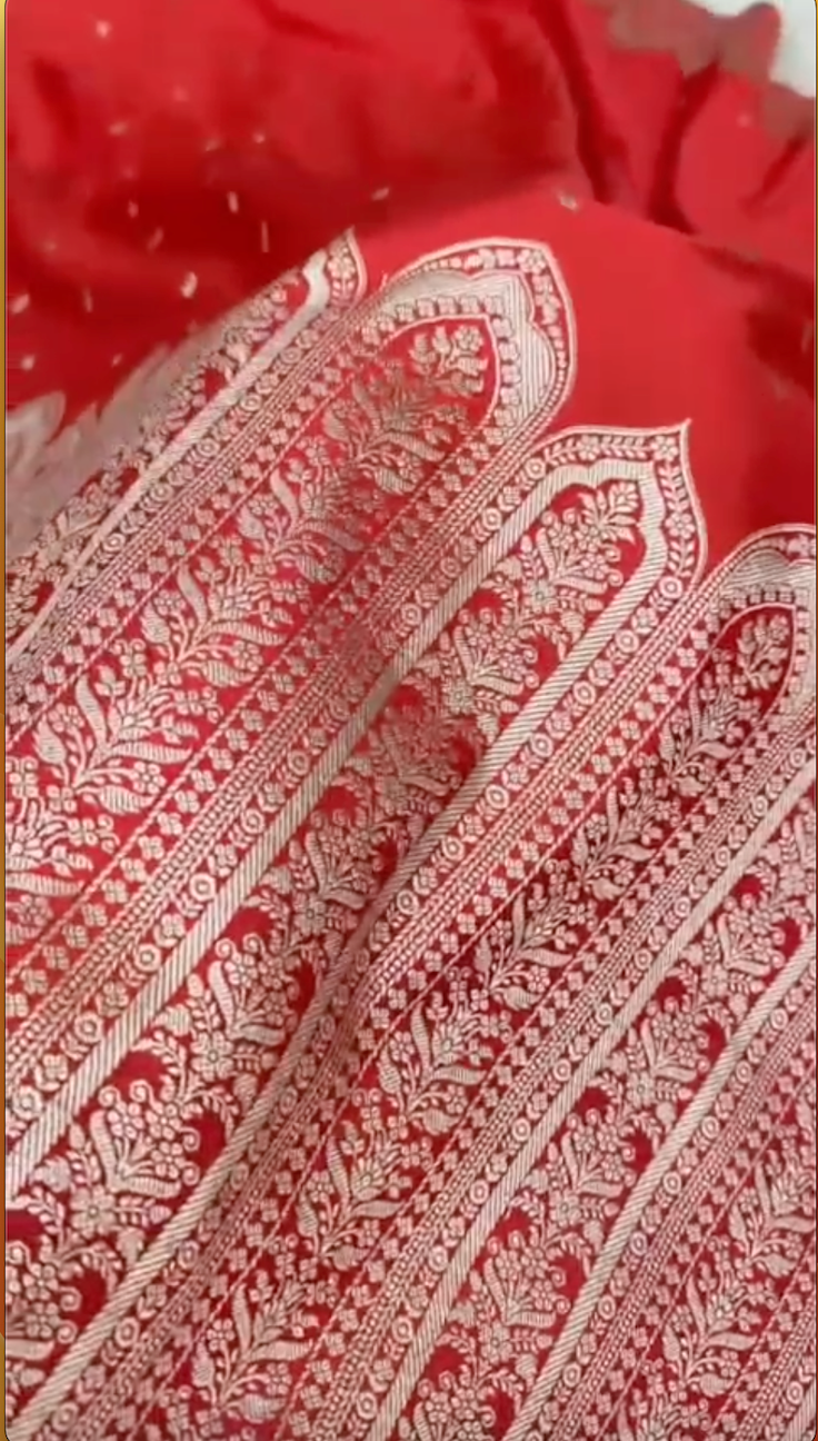 Close-up of a red fabric with intricate white patterns