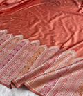 Pink saree with intricate patterns and embellishments on a white background