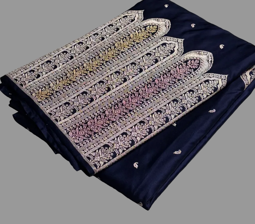 Navy blue fabric with intricate white embroidery on a gray surface, Zara box in the background.