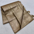 Folded gold fabric with intricate patterns on a light gray background