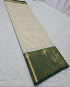 Traditional saree with green border on a white background