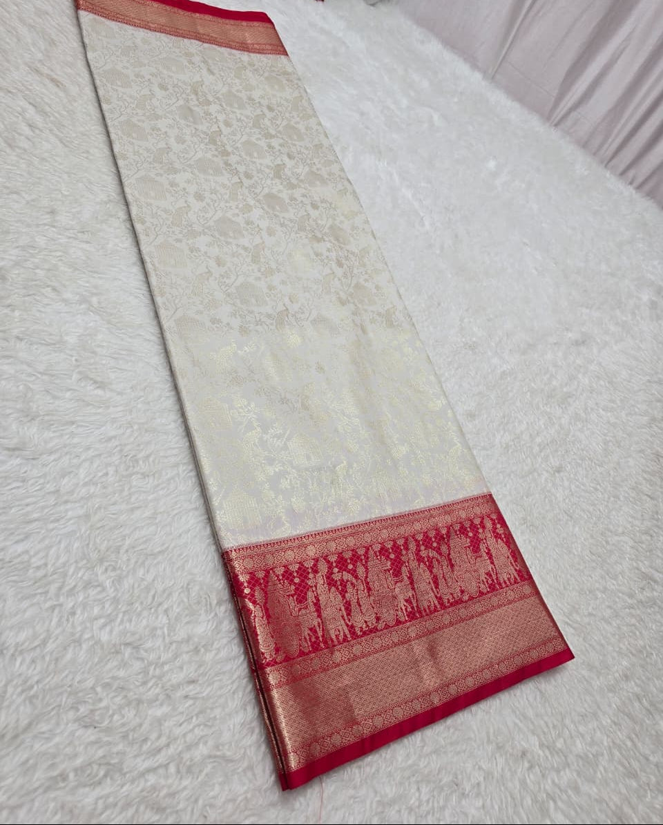 Red and white saree with a pattern on a light gray surface