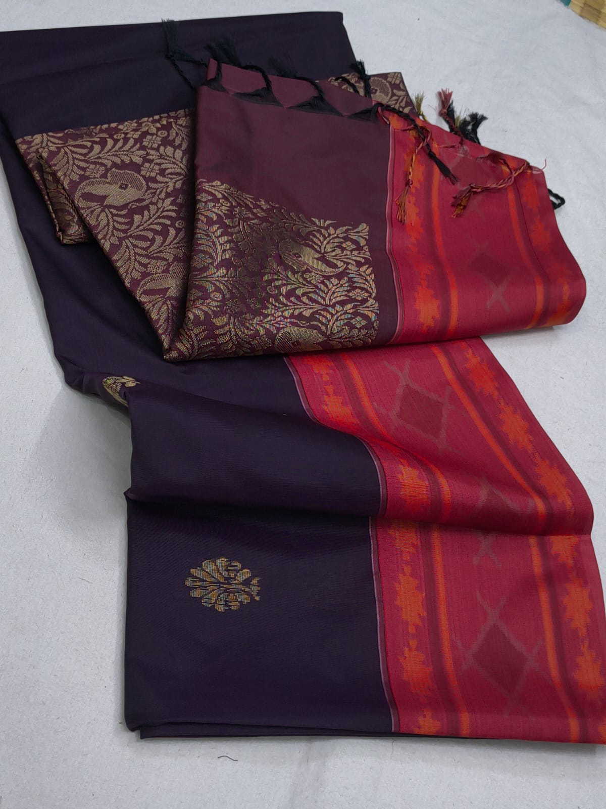 Set of folded sarees in black, purple, and red with intricate patterns on a light gray background.