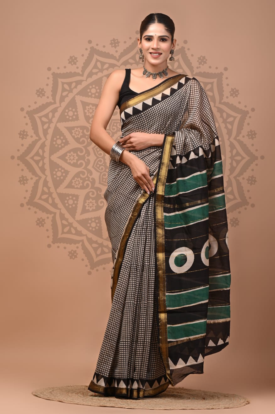 Woman wearing a traditional saree with a geometric pattern on a beige background