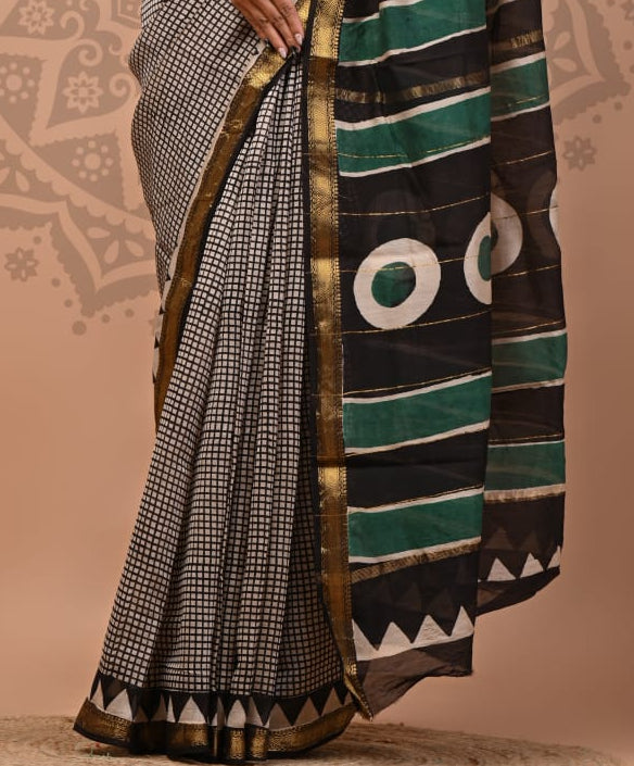 Woman wearing a traditional saree with a geometric pattern on a beige background