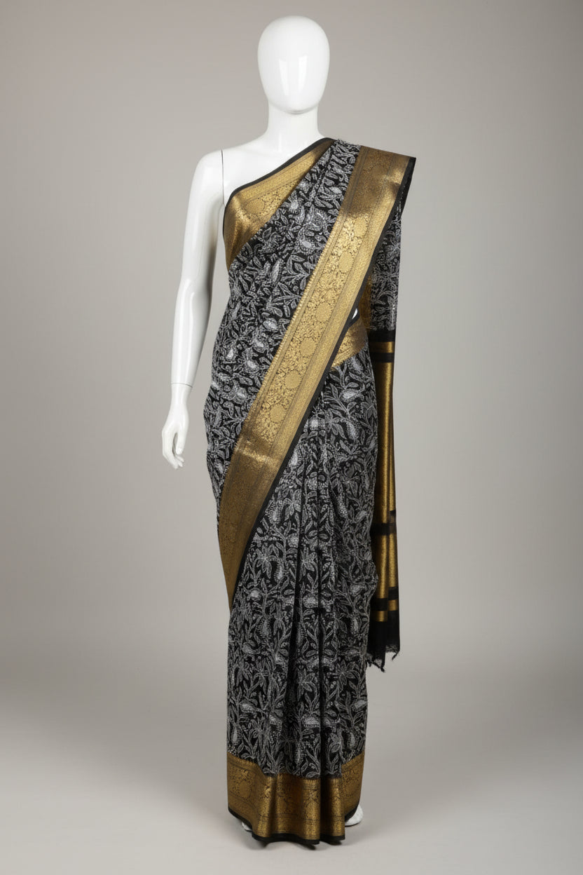 Black saree with white floral patterns and gold border on a red surface