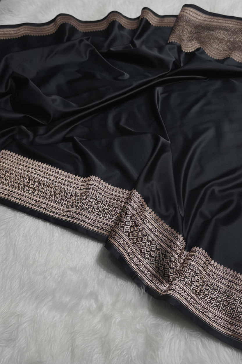Black fabric with intricate lace detailing on a textured surface