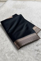 Black scarf with intricate patterns on a white surface, branded 'Zara'.