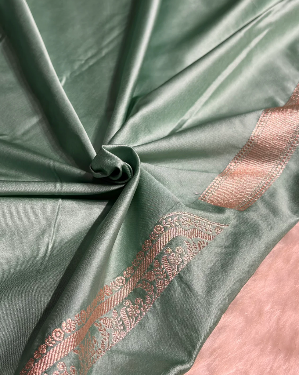 Close-up of green fabric with gold embroidery