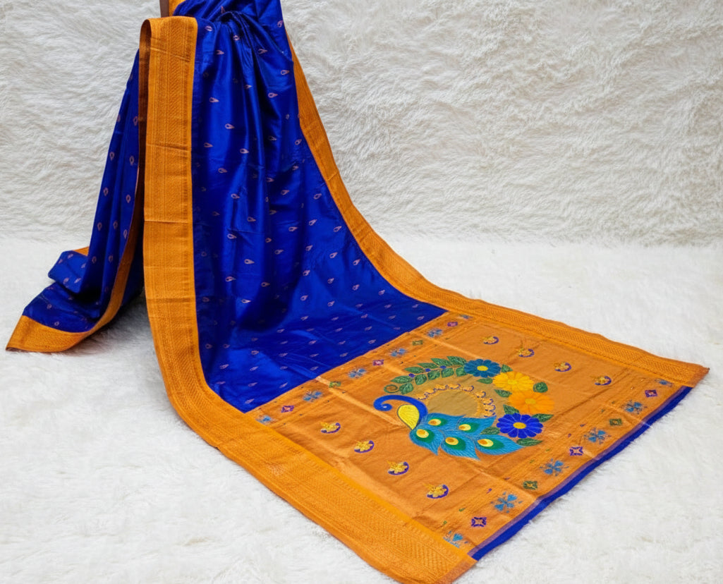 Blue and orange saree with peacock design in a store setting