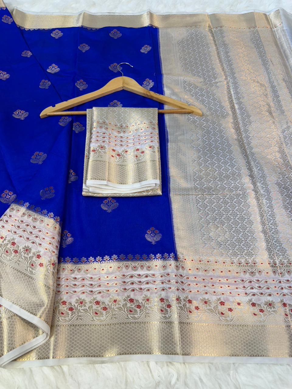Blue saree with gold and white border on a white background