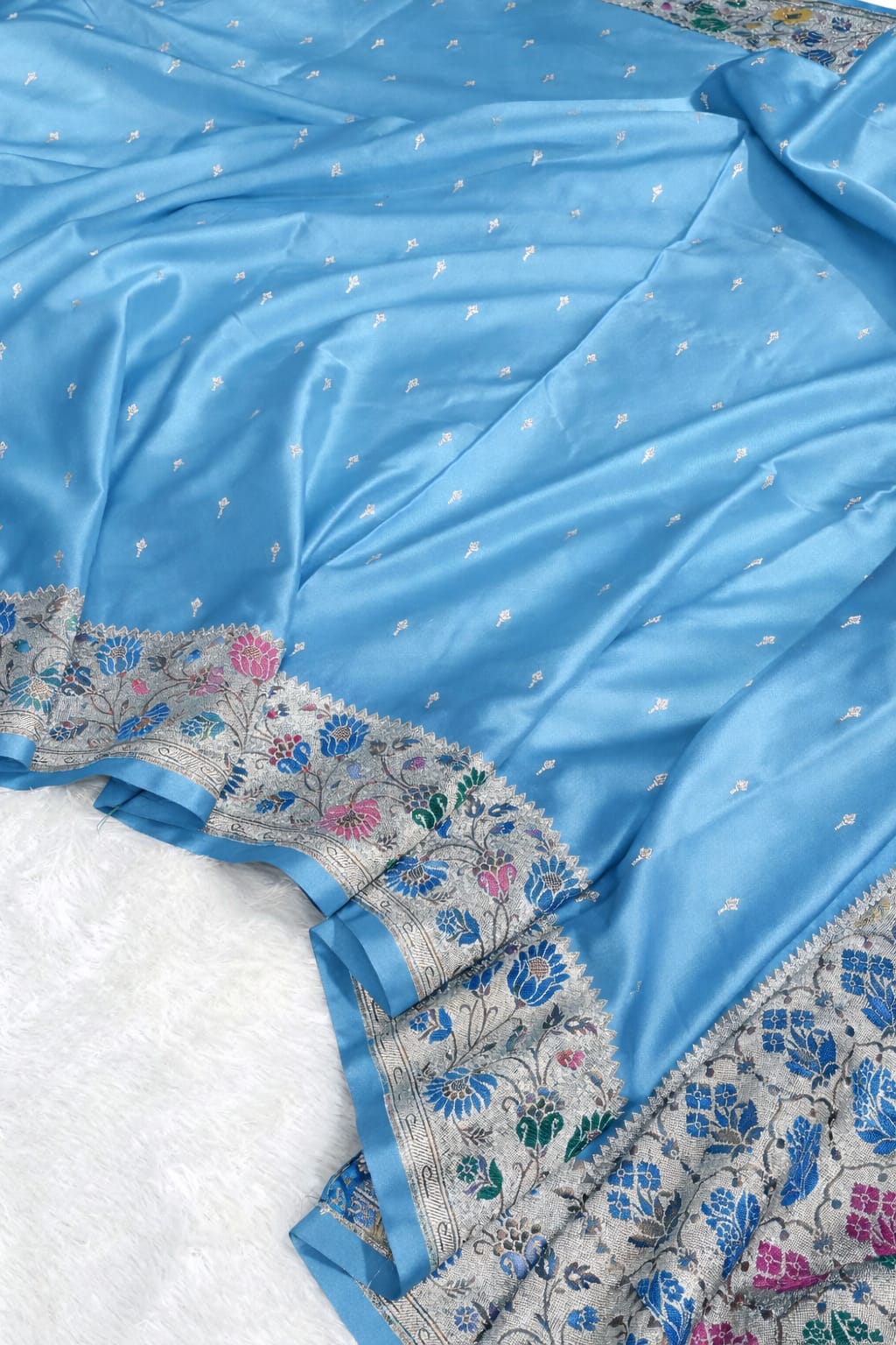 Light blue saree with floral patterns on a white background