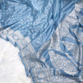Blue fabric with white patterns on a white background
