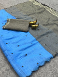 Blue fabric with black patterns and gold accents on a gray surface