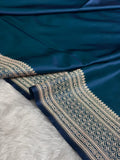 Blue fabric with intricate gold patterns on a white background