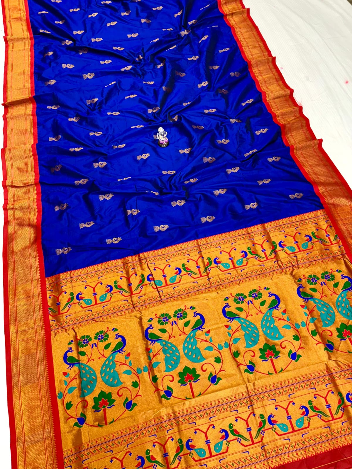 Blue and orange saree with peacock patterns on a white background