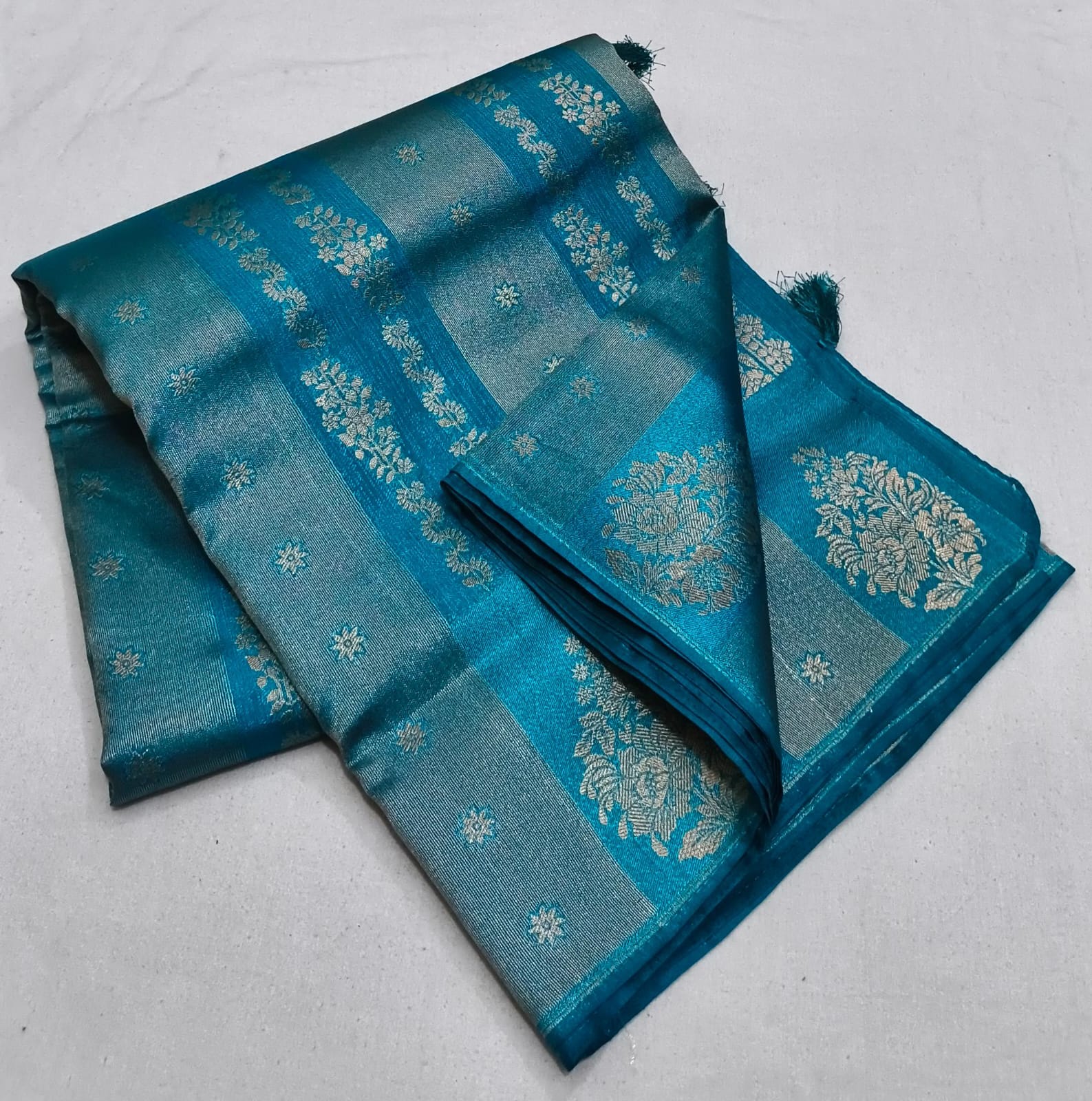Blue fabric with floral patterns on a light gray background