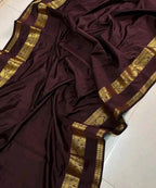 Brown saree with gold border on a light background