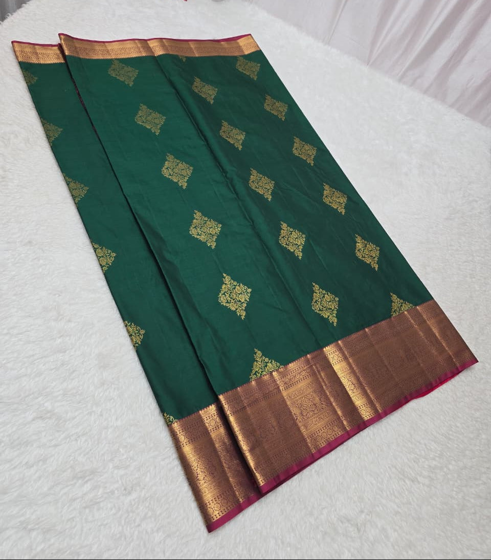 Green saree with gold border on a white surface