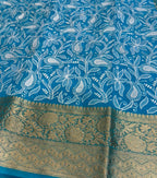 Blue saree with white floral patterns and gold border