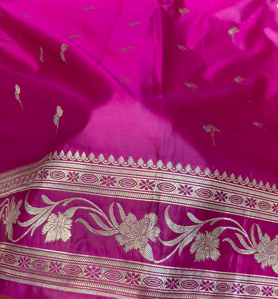 Close-up of a pink fabric with gold embroidery