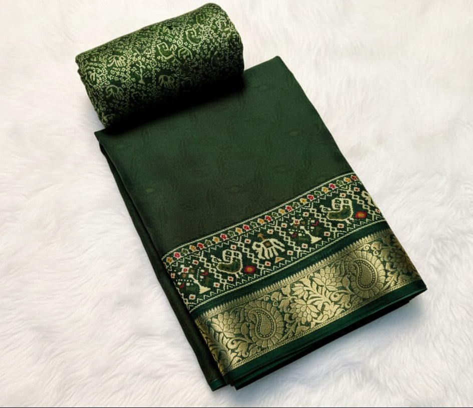 Green saree with floral patterns on a white background with yellow flowers.