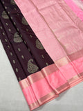 Black and pink saree with gold border on a light gray background