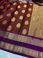 Brown saree with gold patterns on a blue surface