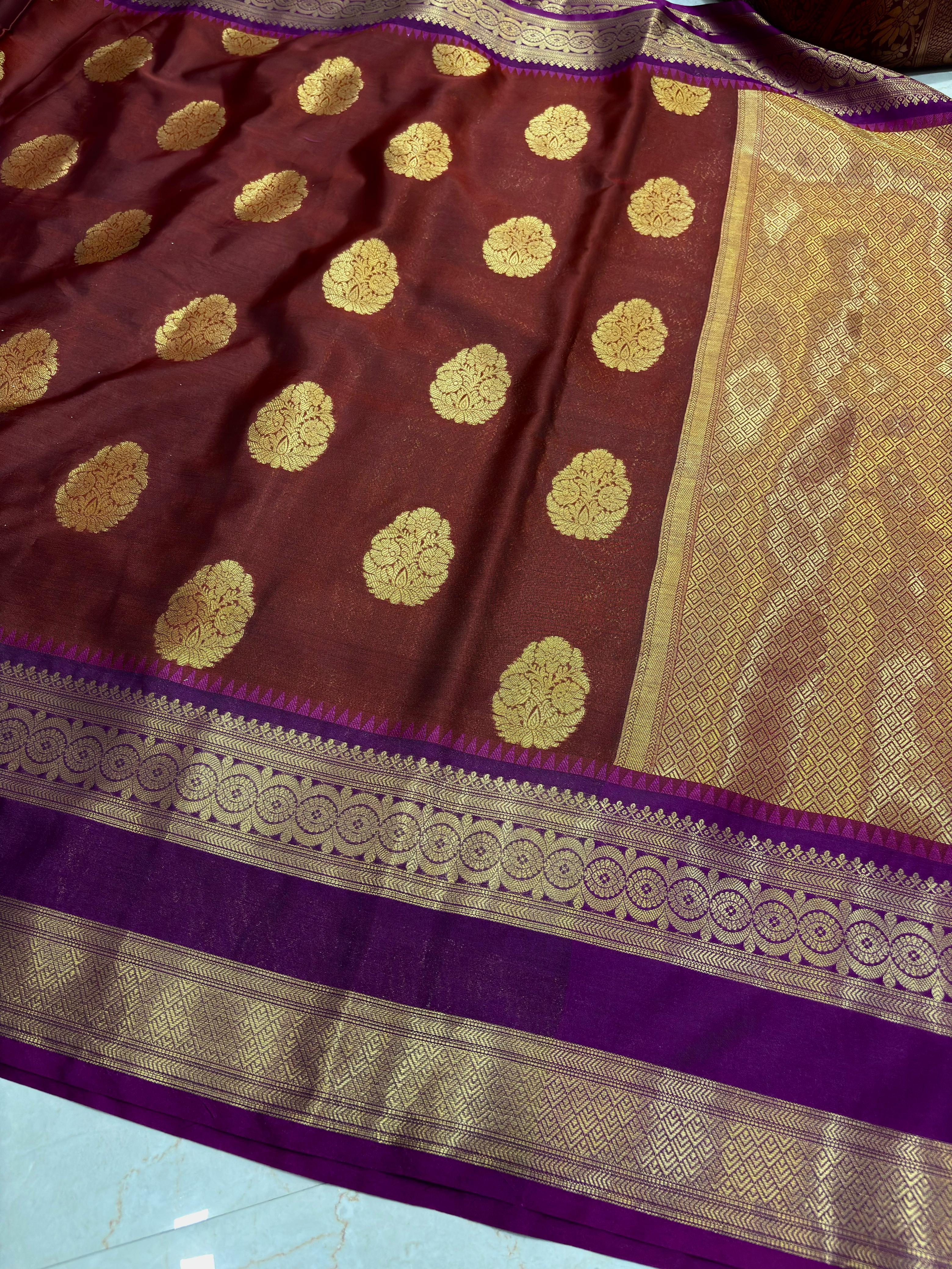 Brown saree with gold patterns on a blue surface