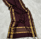 Maroon saree with gold border on a tiled floor
