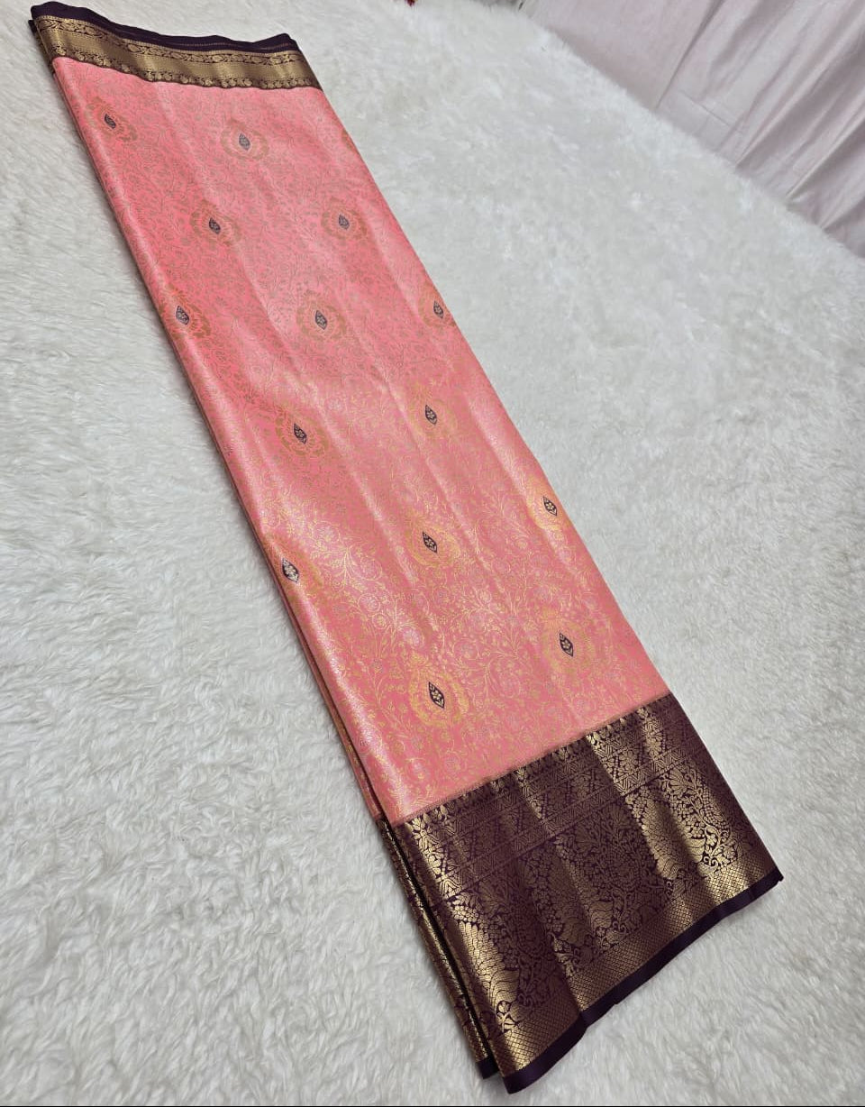 Pink saree with brown border on a white surface