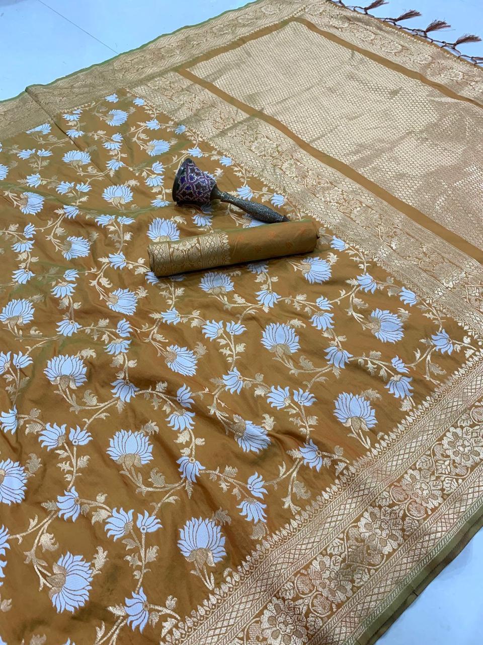 Brown fabric with blue floral patterns and a decorative roll on a light blue background