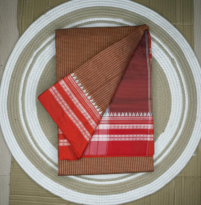 Two patterned cloths, one red and one brown with white designs, on a circular woven mat.