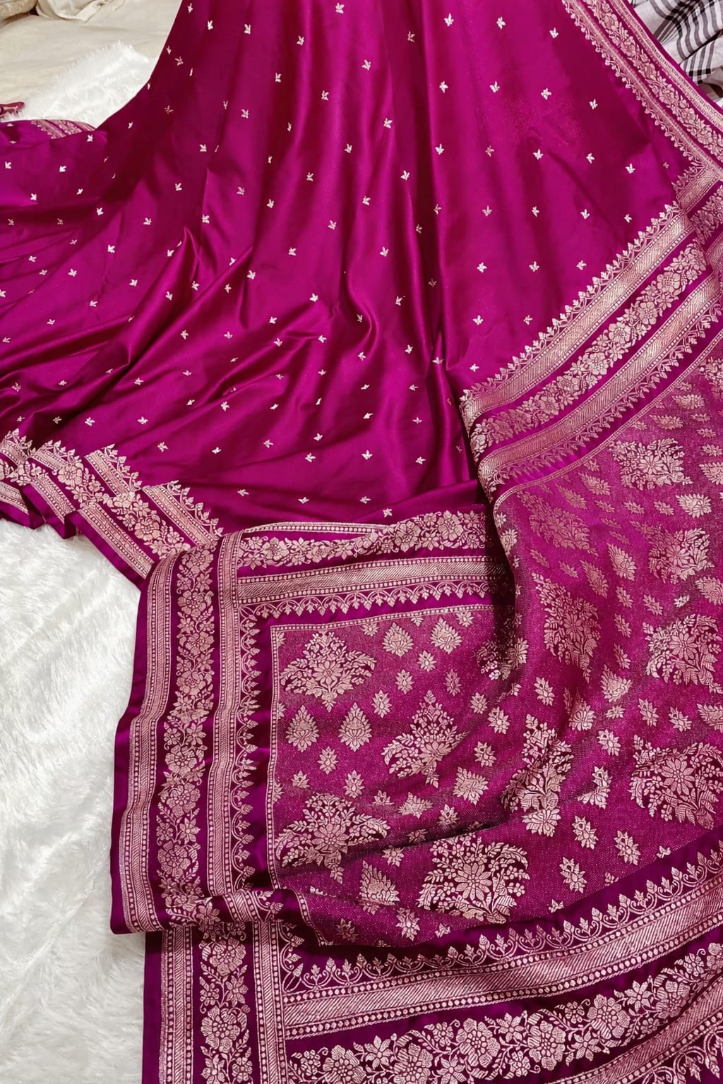 Purple saree with white patterns on a white background