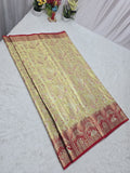 Traditional saree with a red border on a white surface