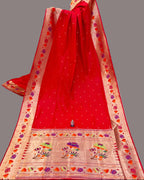Red saree with floral patterns in a store setting