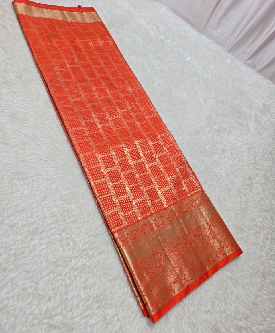 Red saree with a gold border on a white surface