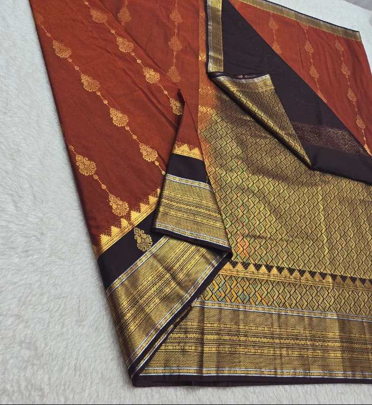 Traditional saree with intricate patterns on a white surface
