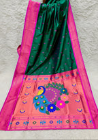 Green and pink saree with peacock design in a store setting