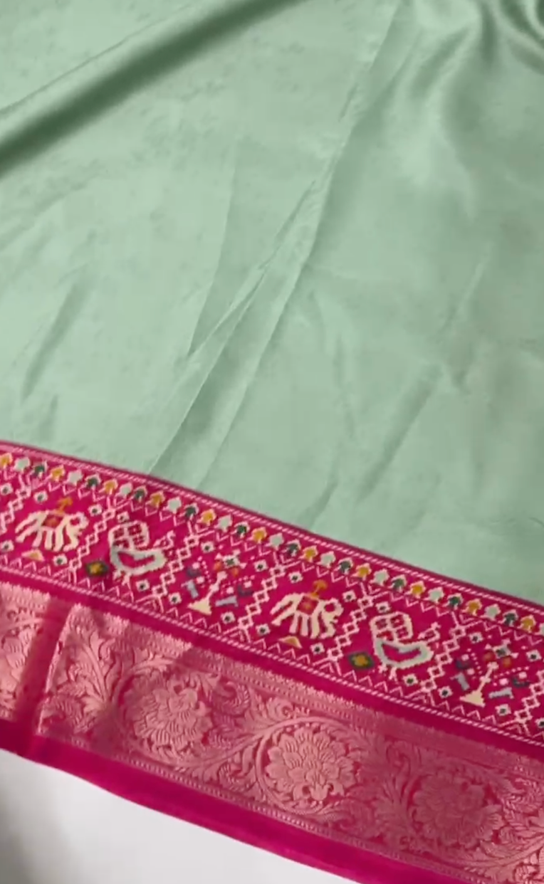 Green fabric with pink embroidered border