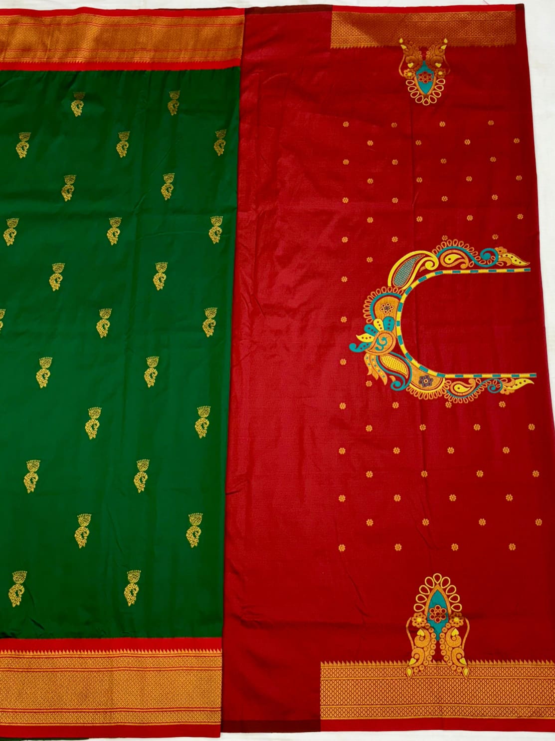 Green and red saree with gold embroidery on a white background