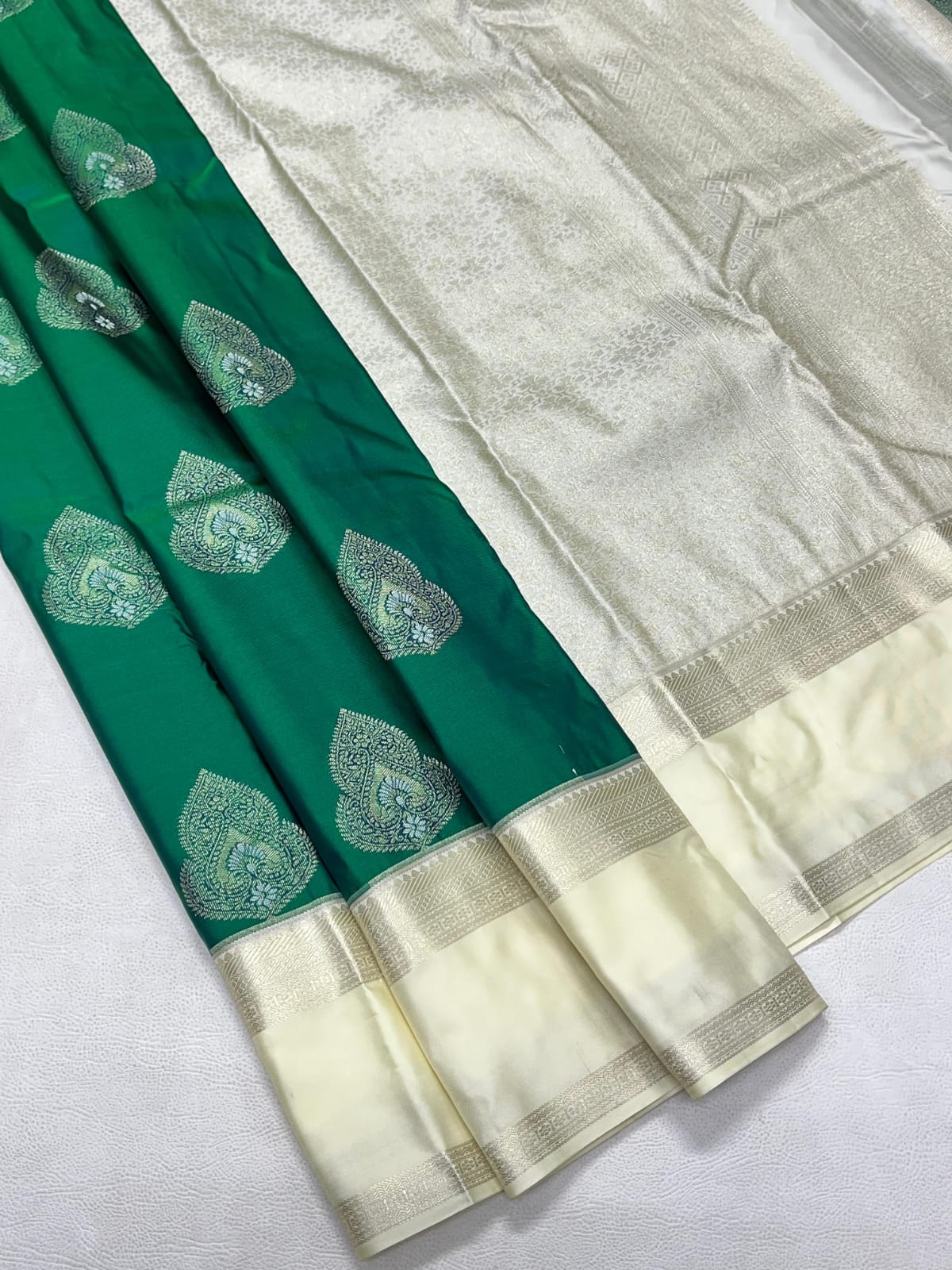 Green and white saree with leaf patterns on a white background