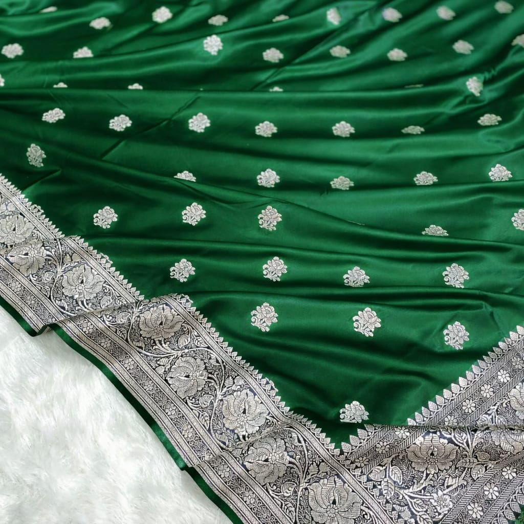 Green saree with silver floral patterns on a white background