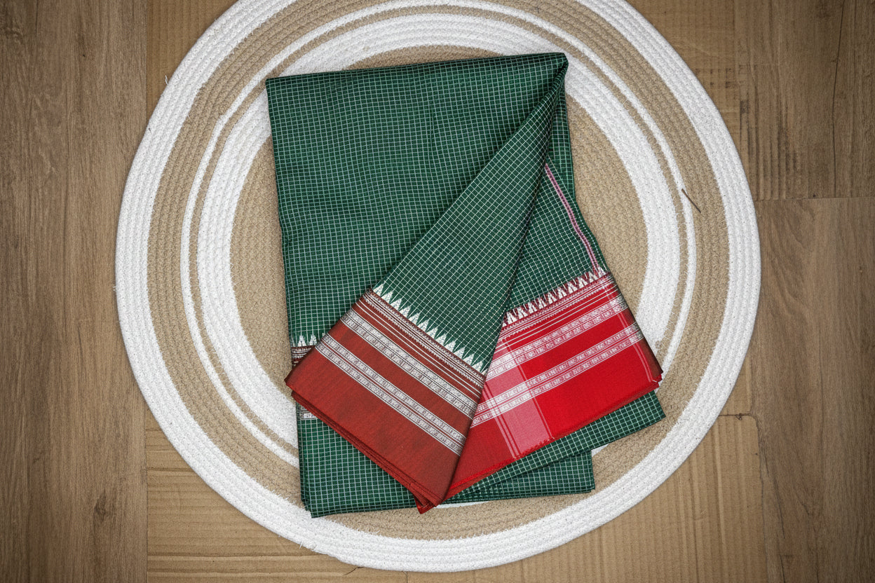 Folded fabric with green, red, and brown patterns on a circular woven mat.