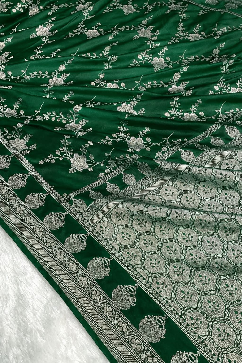 Green fabric with silver floral patterns