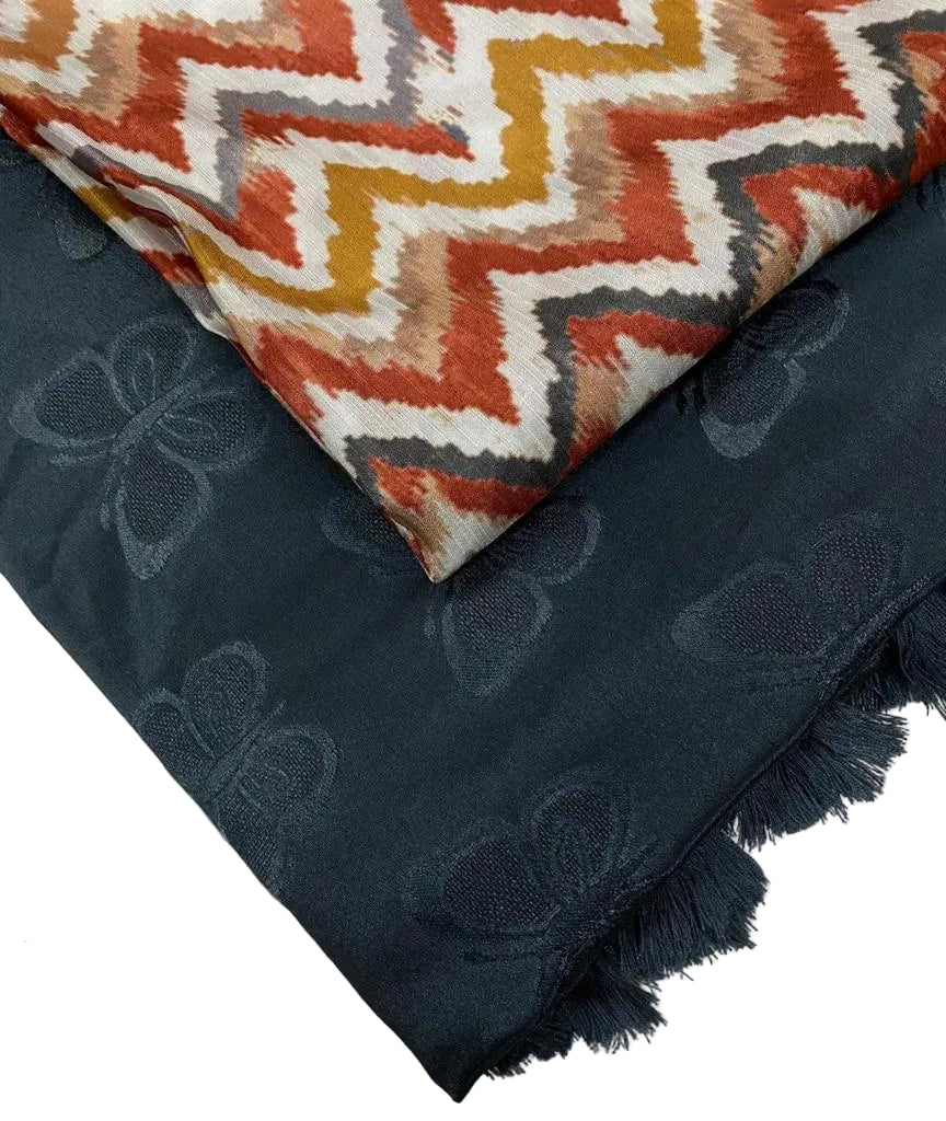 Two fabrics with different patterns and colors on a neutral background.