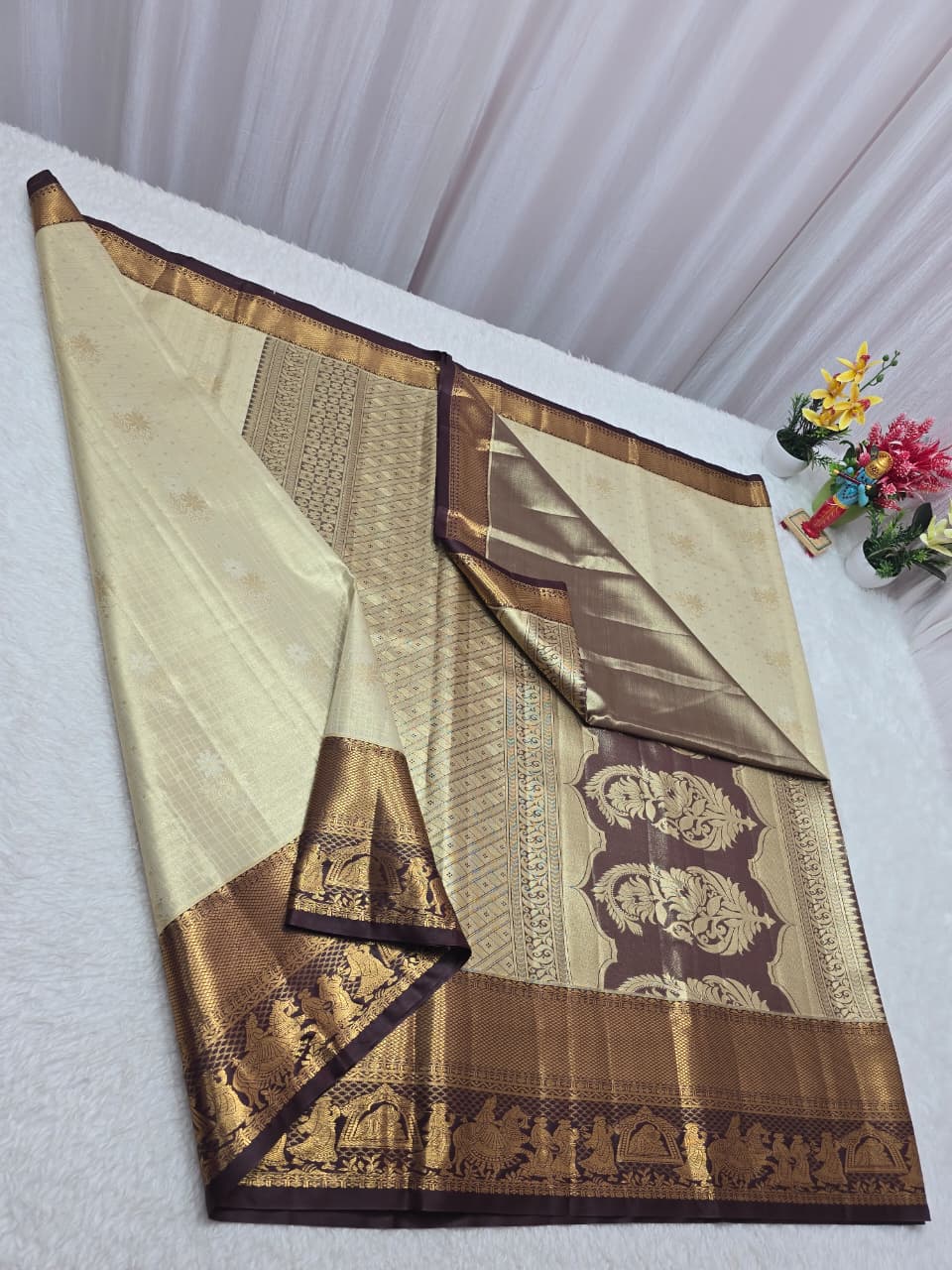 Traditional saree with intricate patterns on a white background