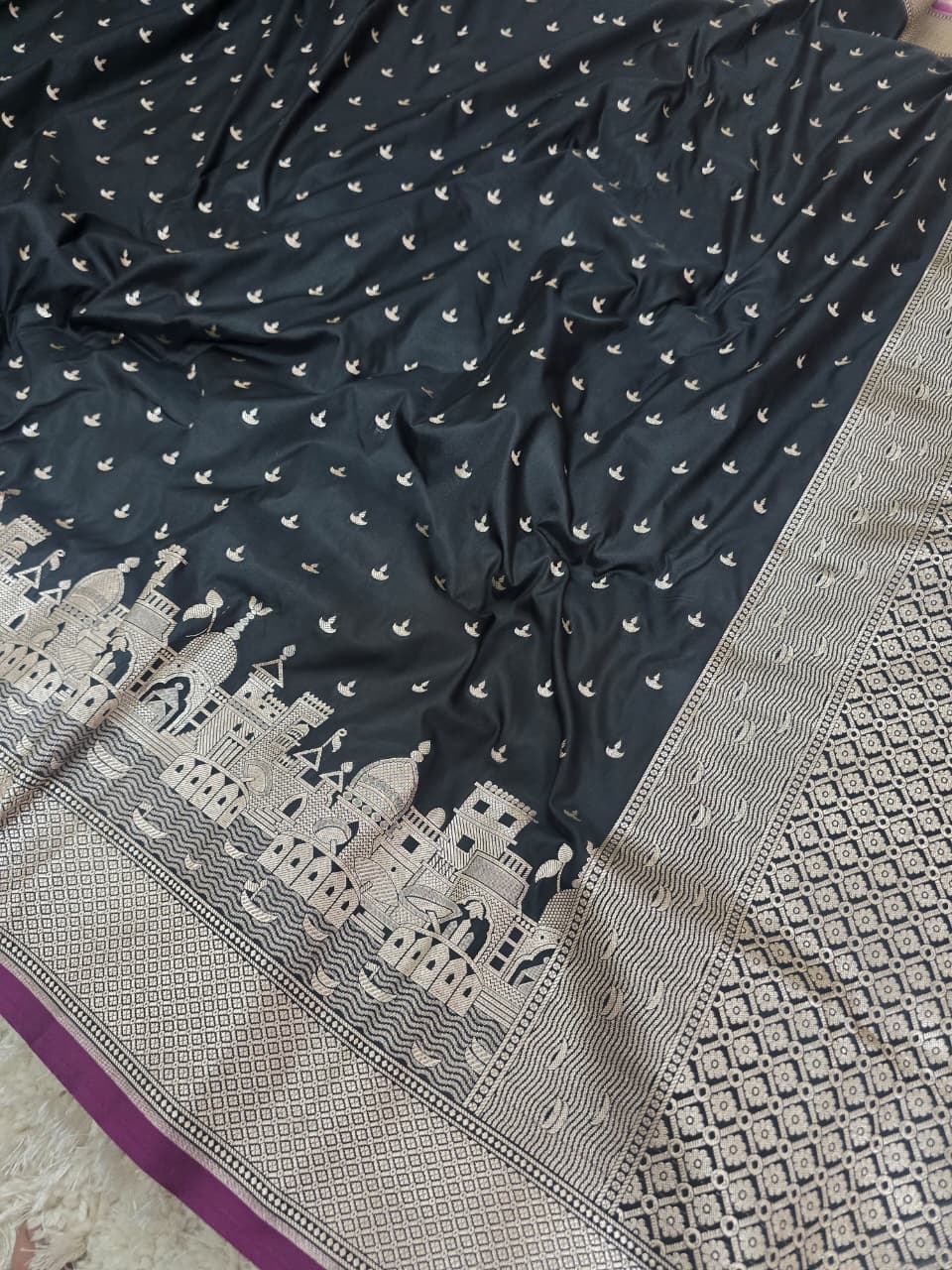 Black fabric with white patterns and a detailed border on a textured surface