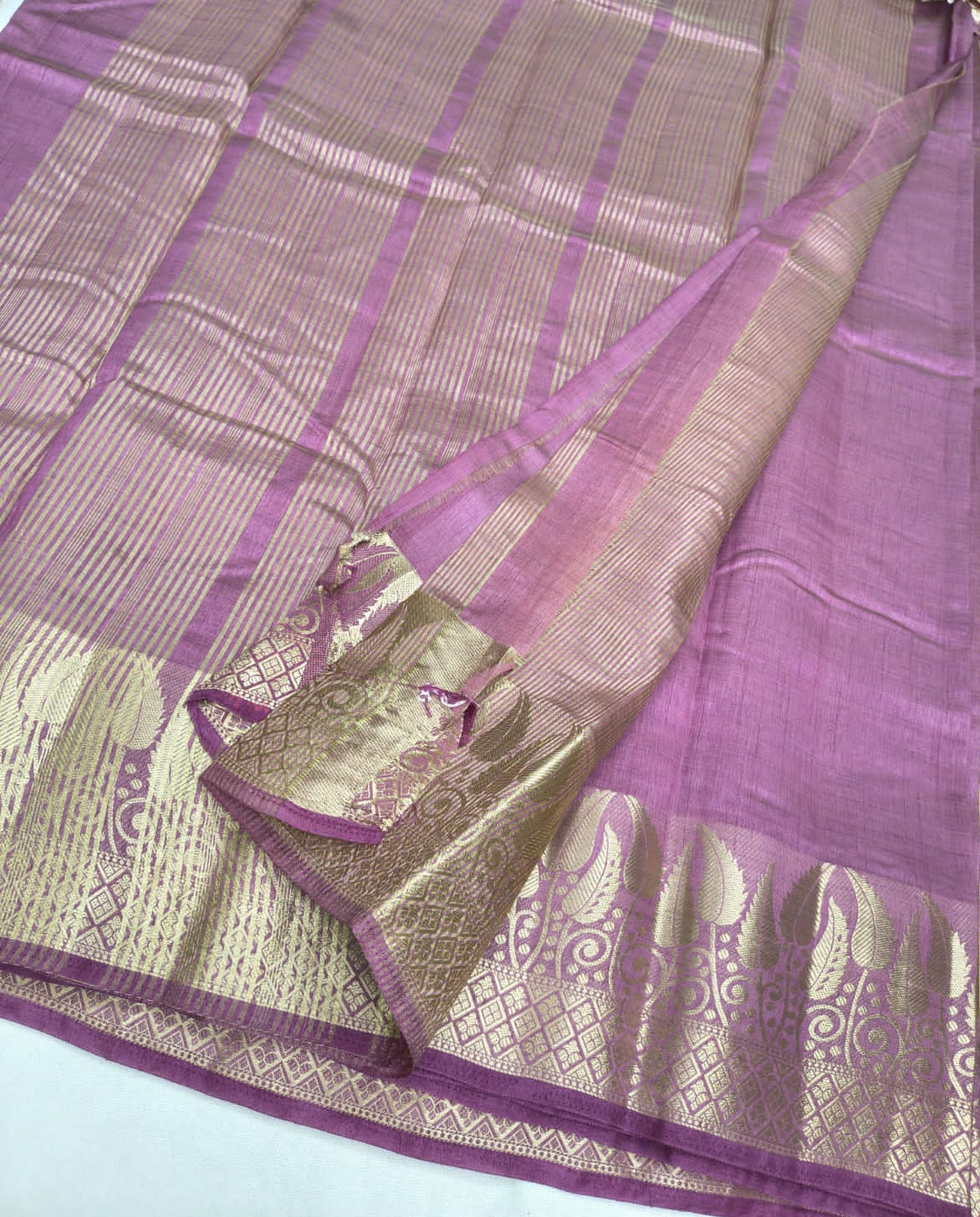 Purple saree with a patterned border on a white background
