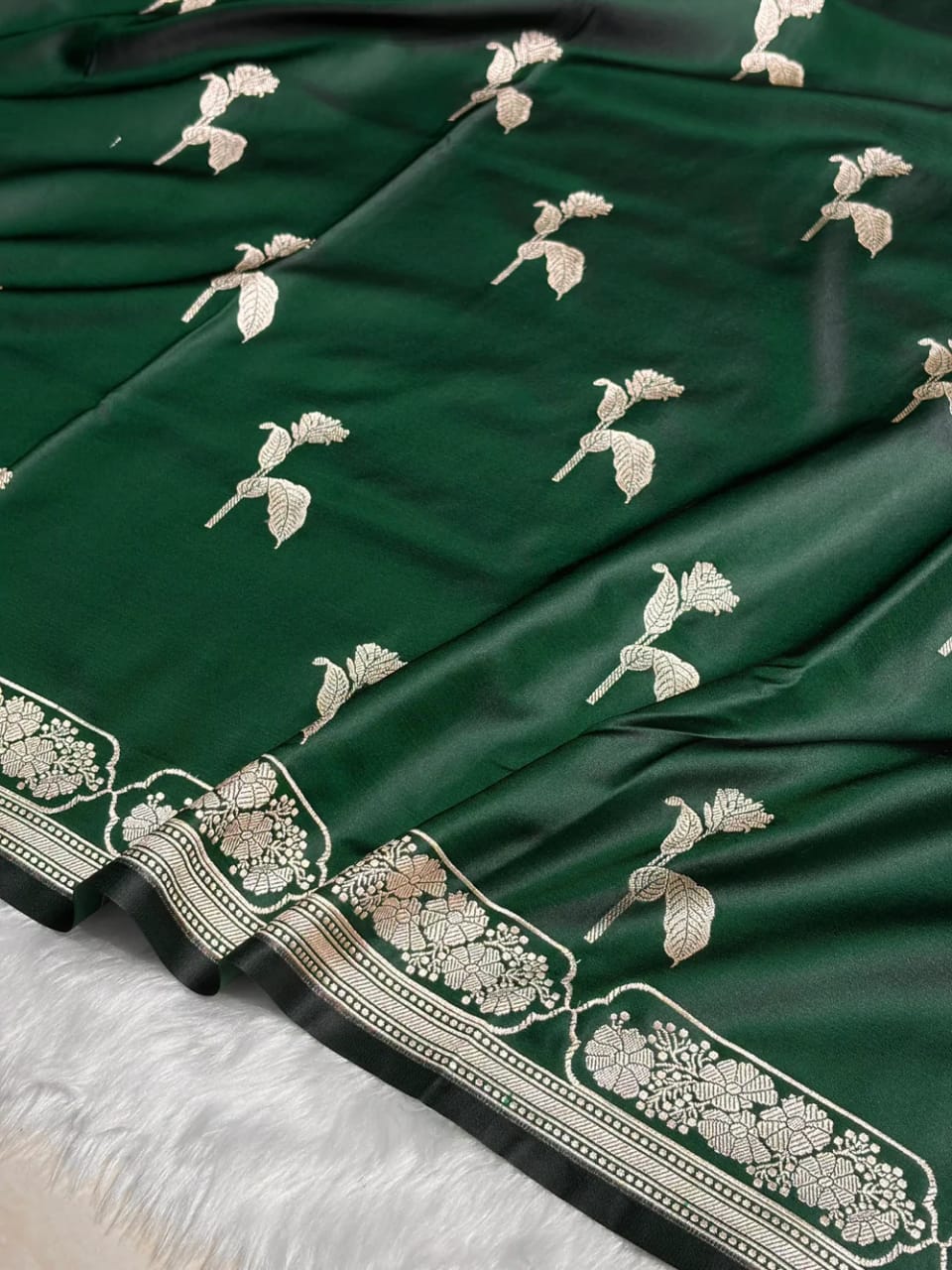 Green fabric with white floral embroidery